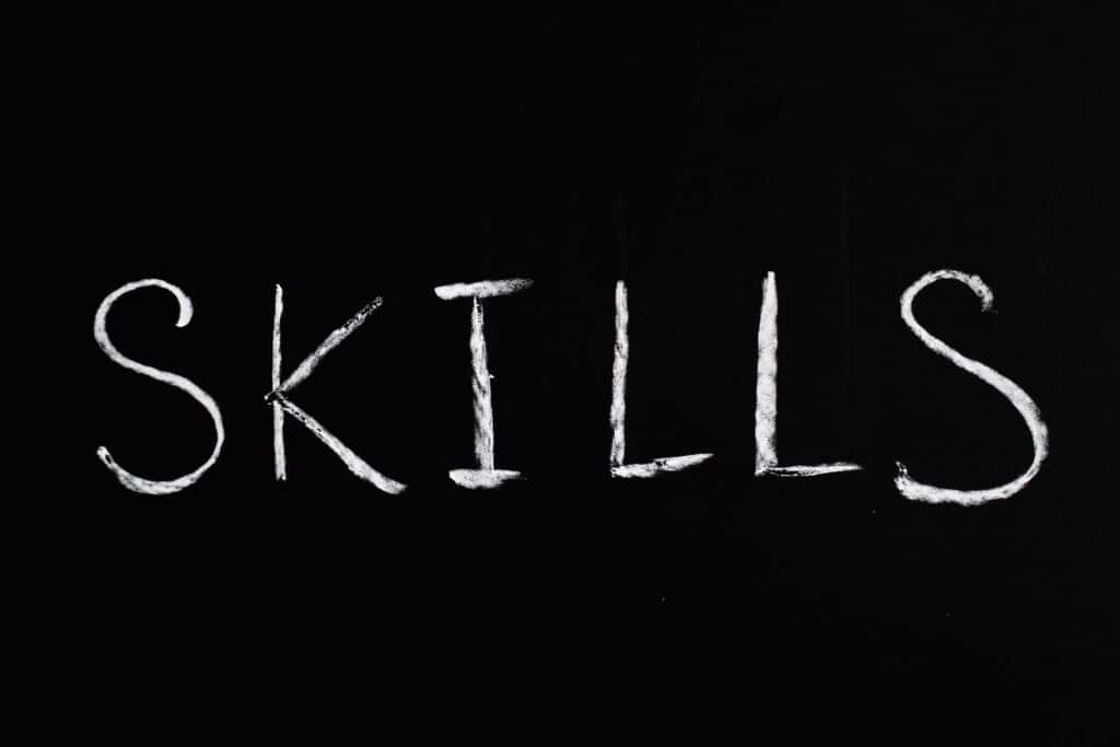 Chalk lettering of the word 'skills' on a blackboard, emphasizing learning and education.