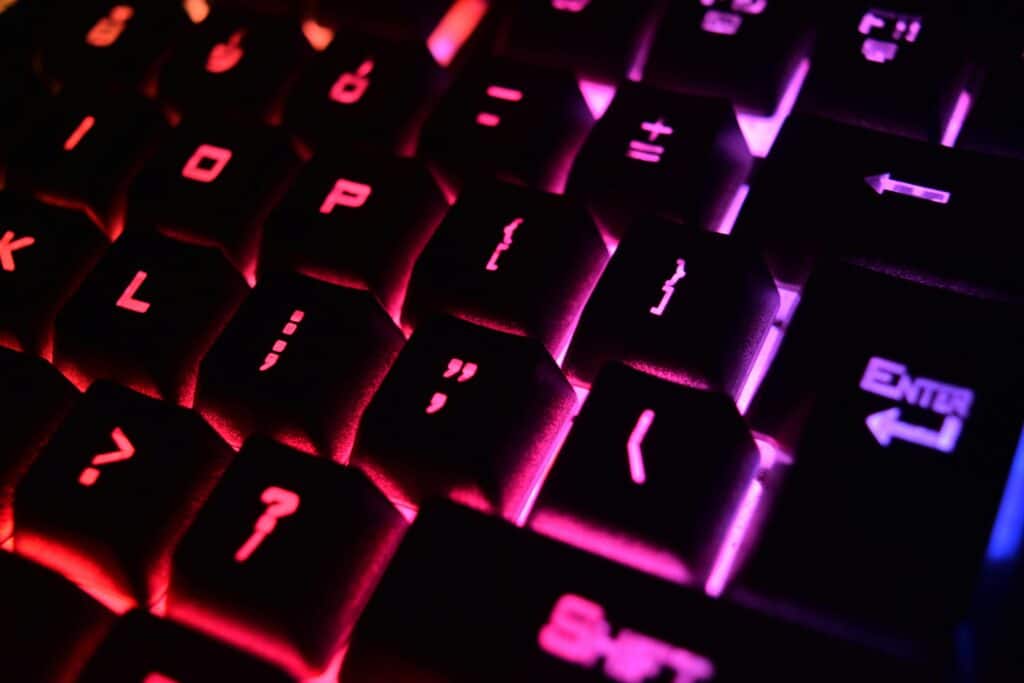 Vibrant close-up of a modern RGB backlit mechanical keyboard with glowing keys.