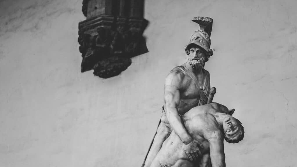 Black and white photo of a classical marble statue in Tuscany, Italy.