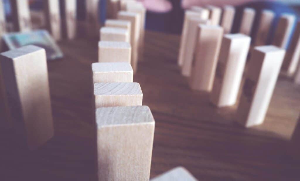 Artistic close-up of wooden blocks lined up on a table indoors.