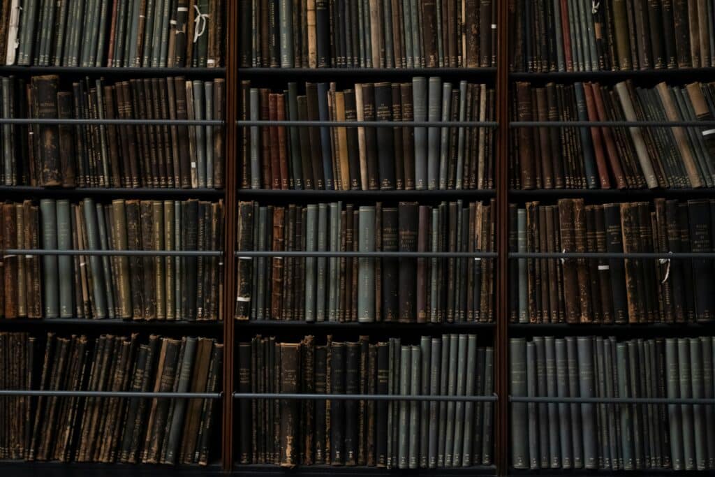 A close-up of vintage books on library shelves in London, showcasing an abundance of literary history.