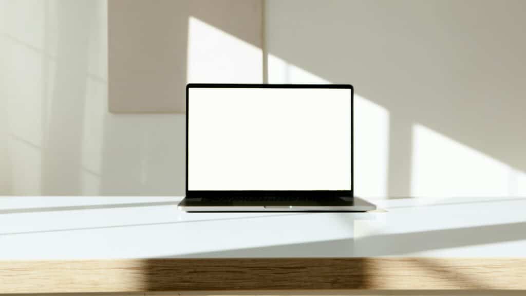 A laptop with a blank screen displayed on a stylish desk, ready for customization.