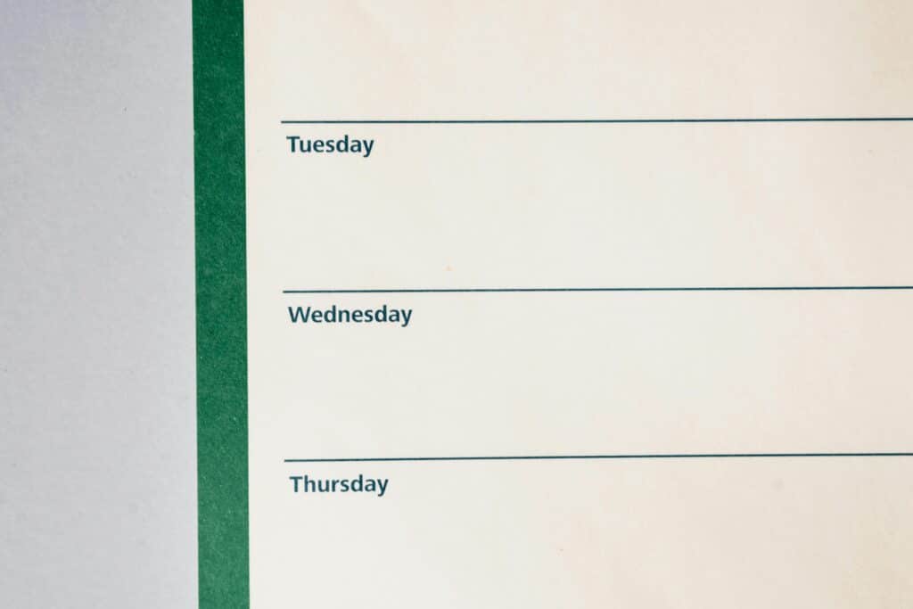 Close-up view of a minimalist weekly planner featuring days of the week.