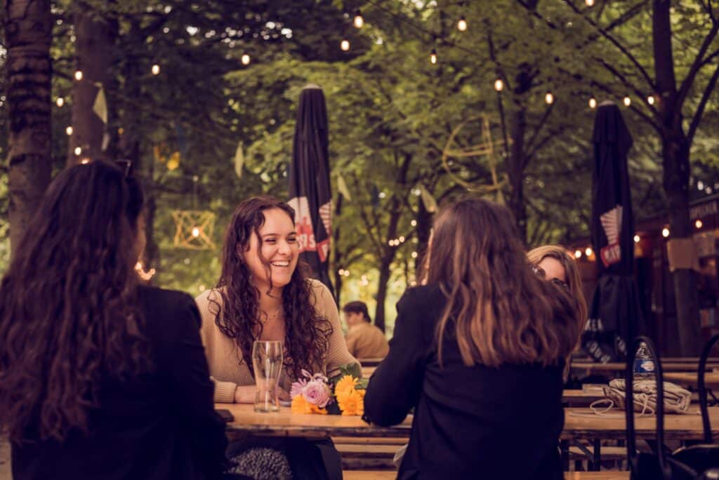 Group of women enjoying conversation at an outdoor cafe in Brussels.