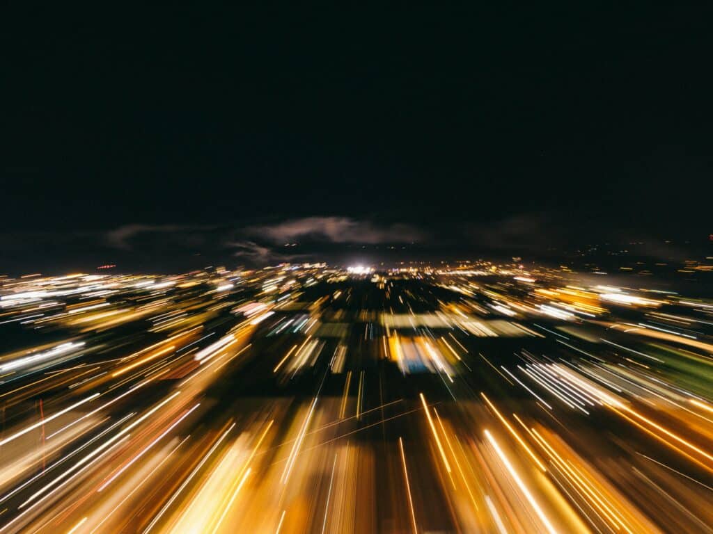 Blurred city lights captured with a long exposure, creating dynamic motion effects.