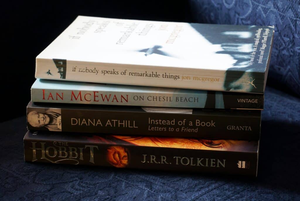A stack of classic novels including works by McEwan, Athill, McGregor, and Tolkien.