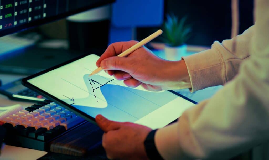 Hand-drawn business graph on a tablet showing The Truth About Multitasking