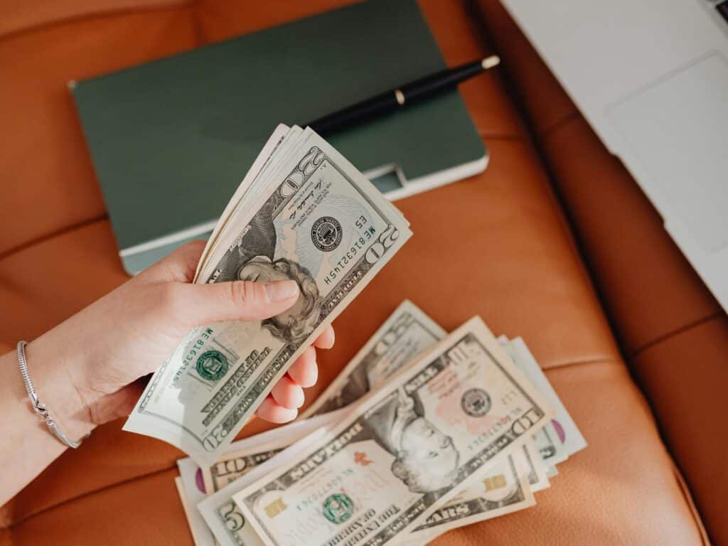 Guy showing money made from side hustles for high school students