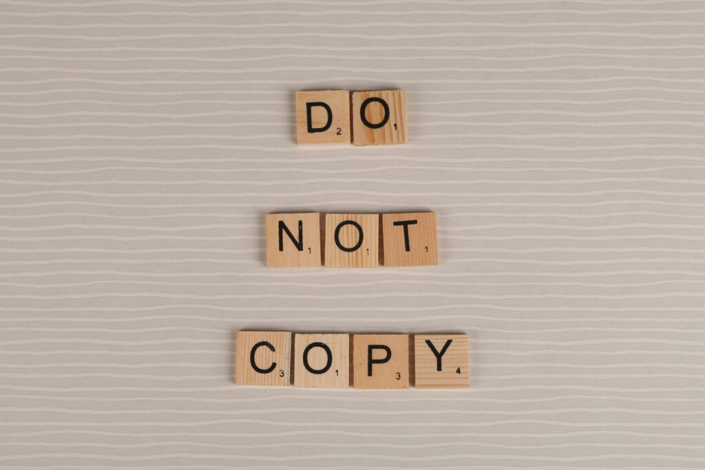 Close-up of wooden tiles spelling 'Do Not Copy' on How to Find Credible Sources for a Research Paper